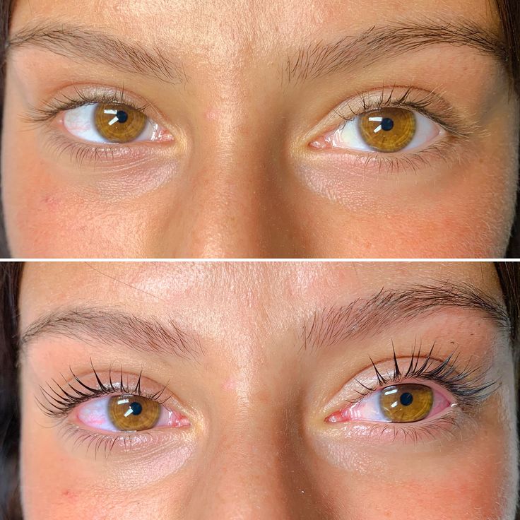 Happy client checking new lash extensions in handheld mirror.