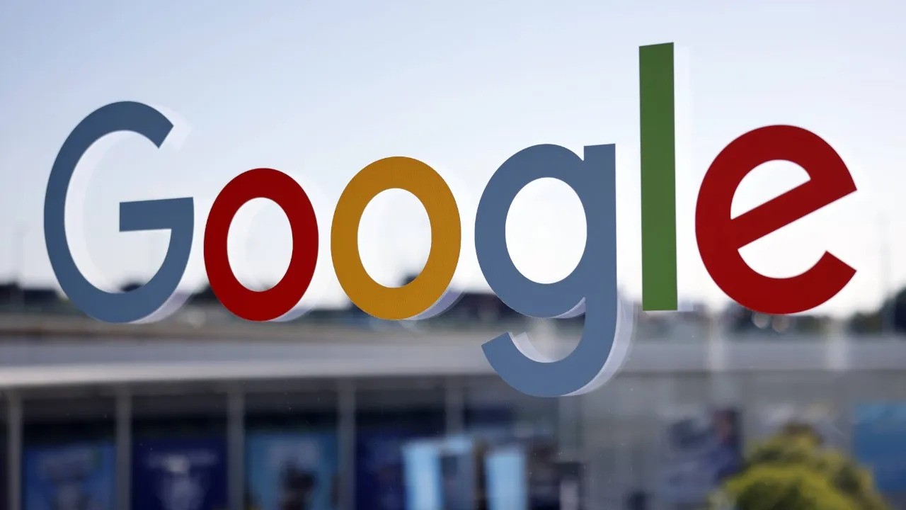 Google logo in blue, red, yellow, and green colors displayed on a blurry background. 