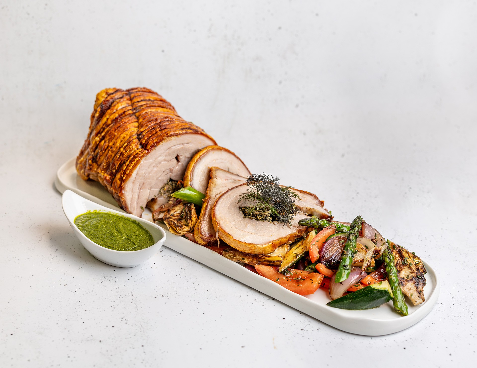 Fennel & sage porchetta with salsa verde & Tuscan roasted vegetables