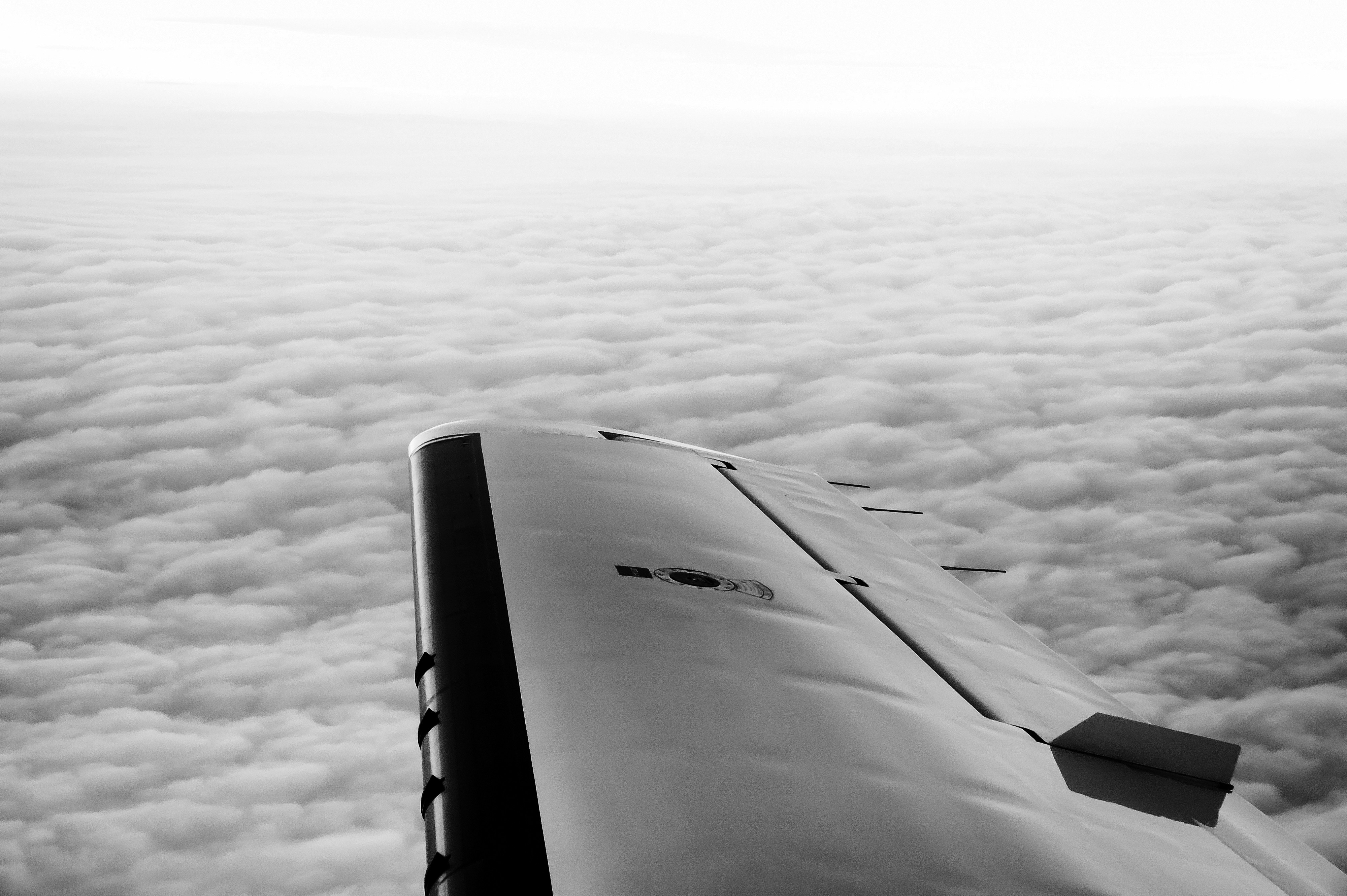 Close-up of a hair dryer nozzle with a black circular vent, against a textured background.