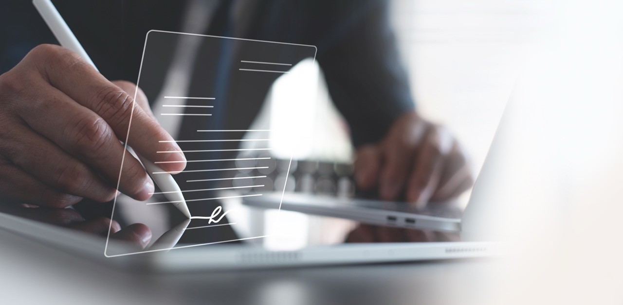 A businessman working on his laptop in an office.