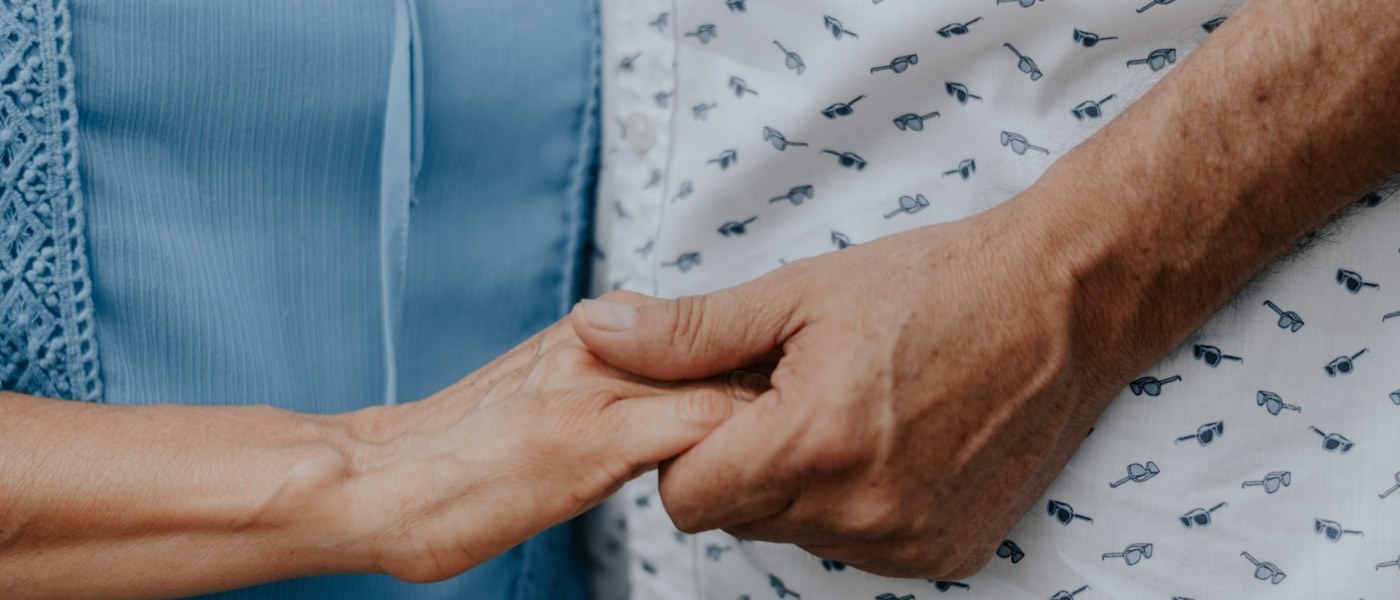 A carer holding a client's hands