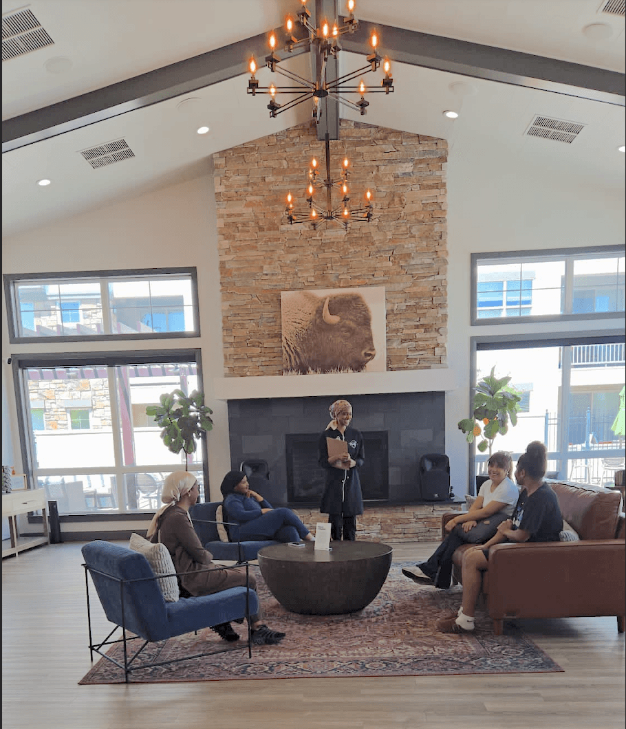 A woman receives a relaxing energy healing in a serene setting with soft lighting.
