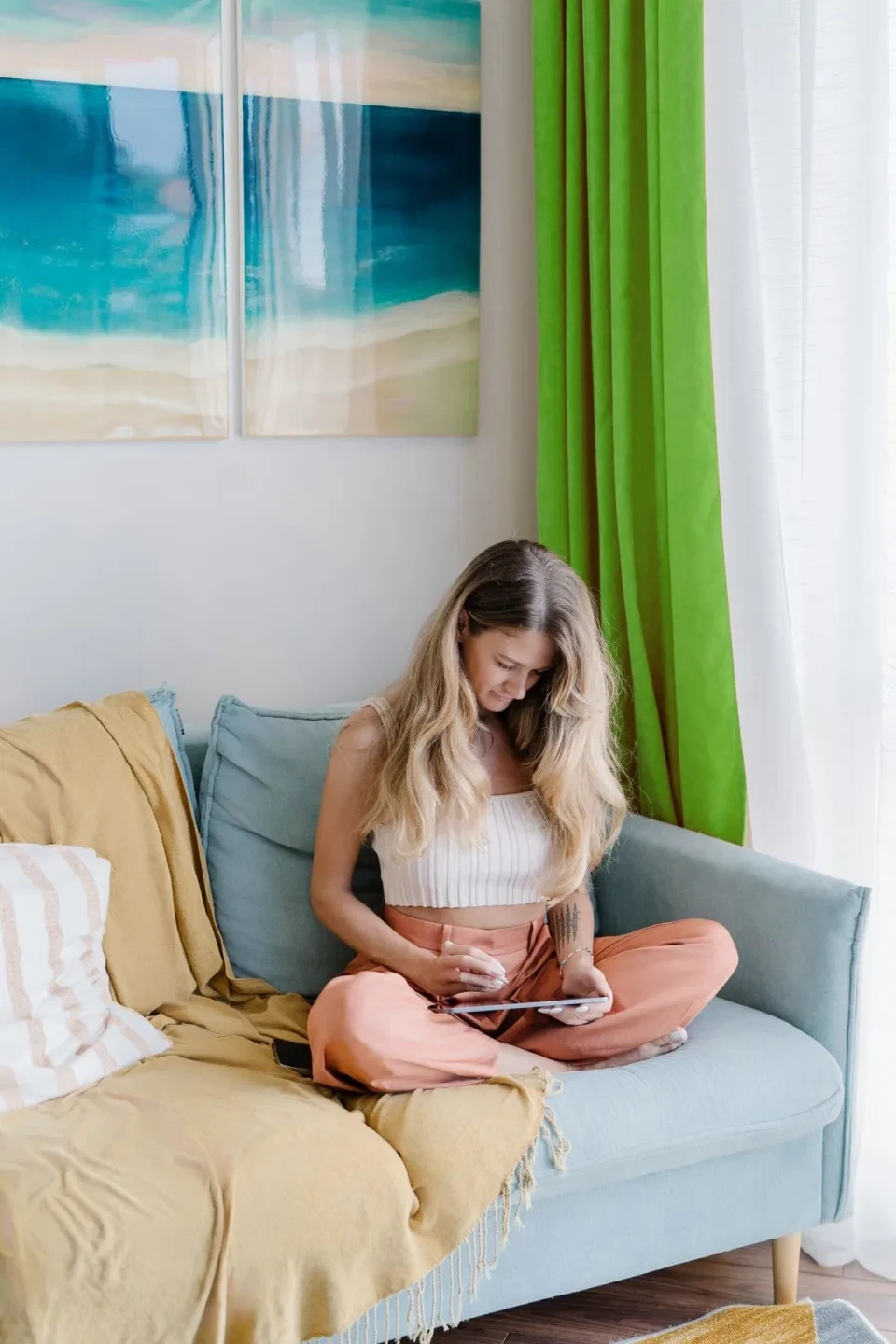 two people looking at a tablet and smiling
