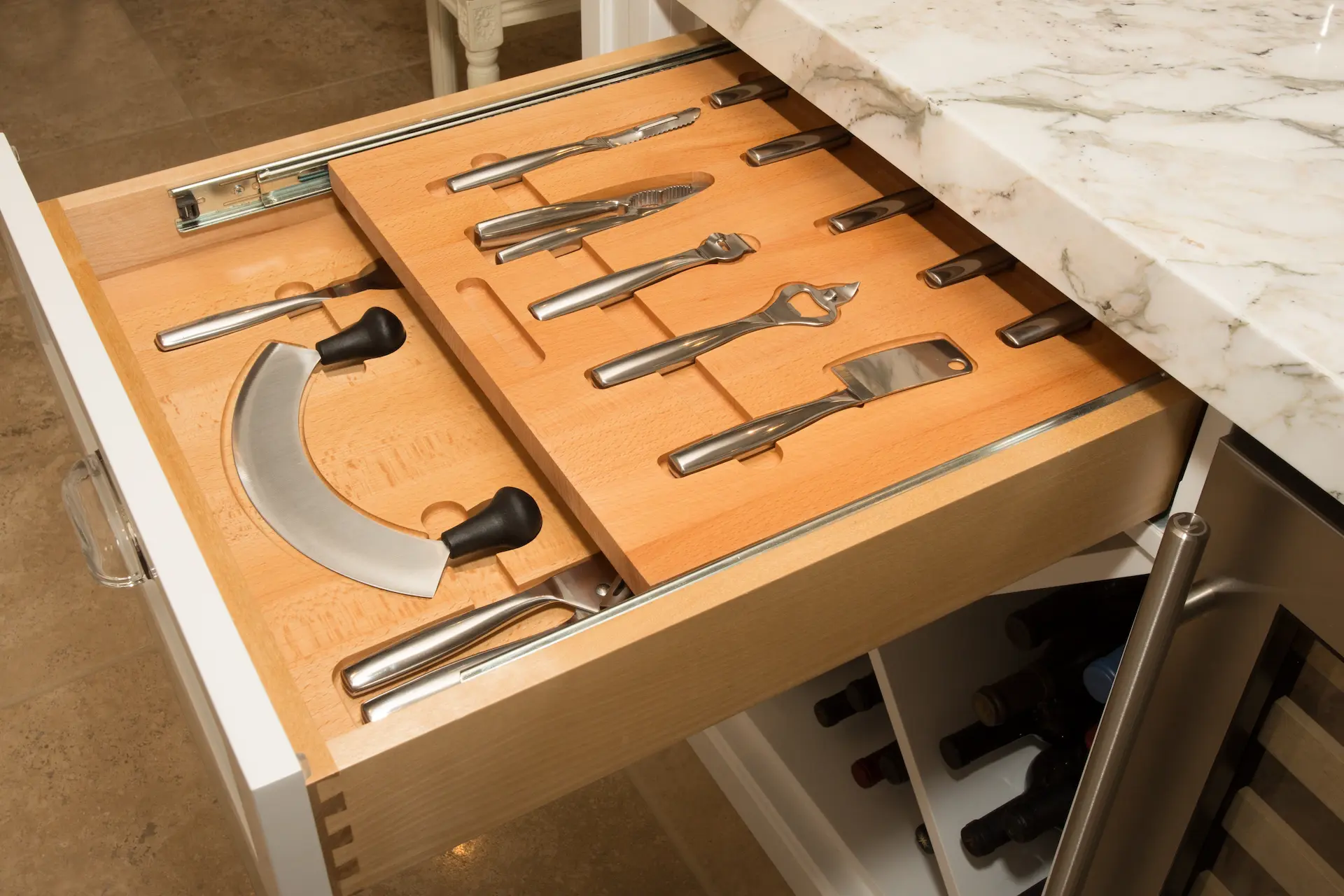 Custom kitchen drawer with organized utensils, including a pizza cutter, in Newport Beach Remodel.