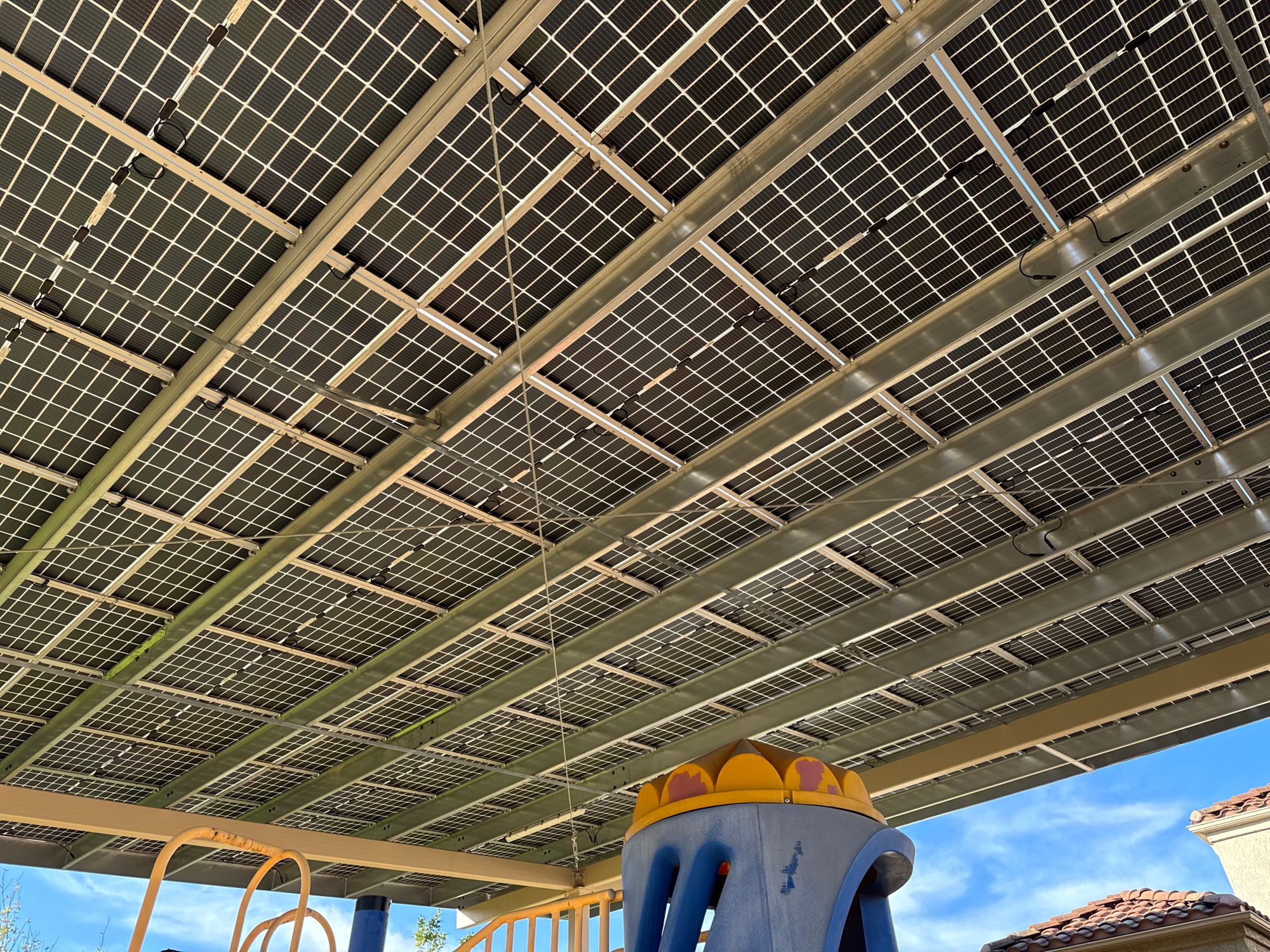 Underside of a solar canopy shading a school playground