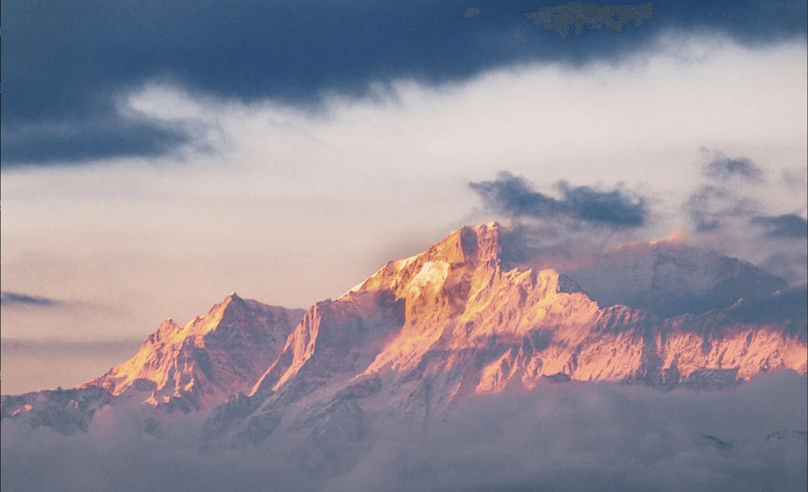 snow covered mountain during sunset