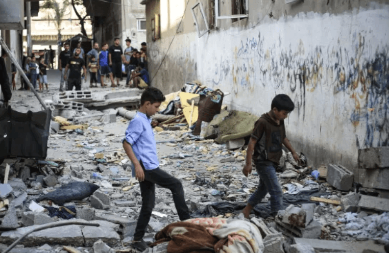 Palestinians face the aftermath of an Israeli strike in the Nuseirat refugee camp in central Gaza on Saturday. (Photo courtesy of Eyad Baba)