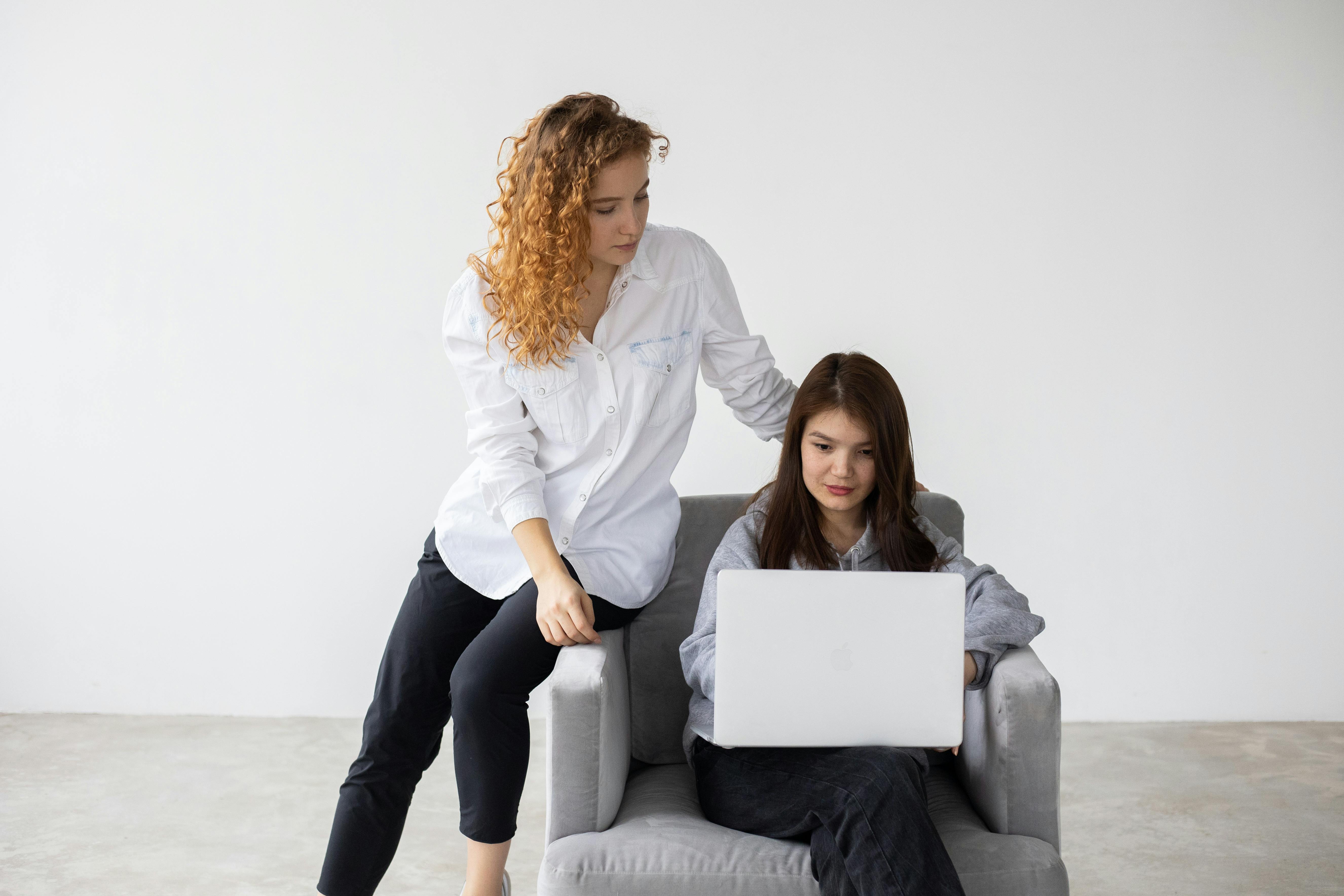 Colleagues working together on laptop crafting a ceo emails