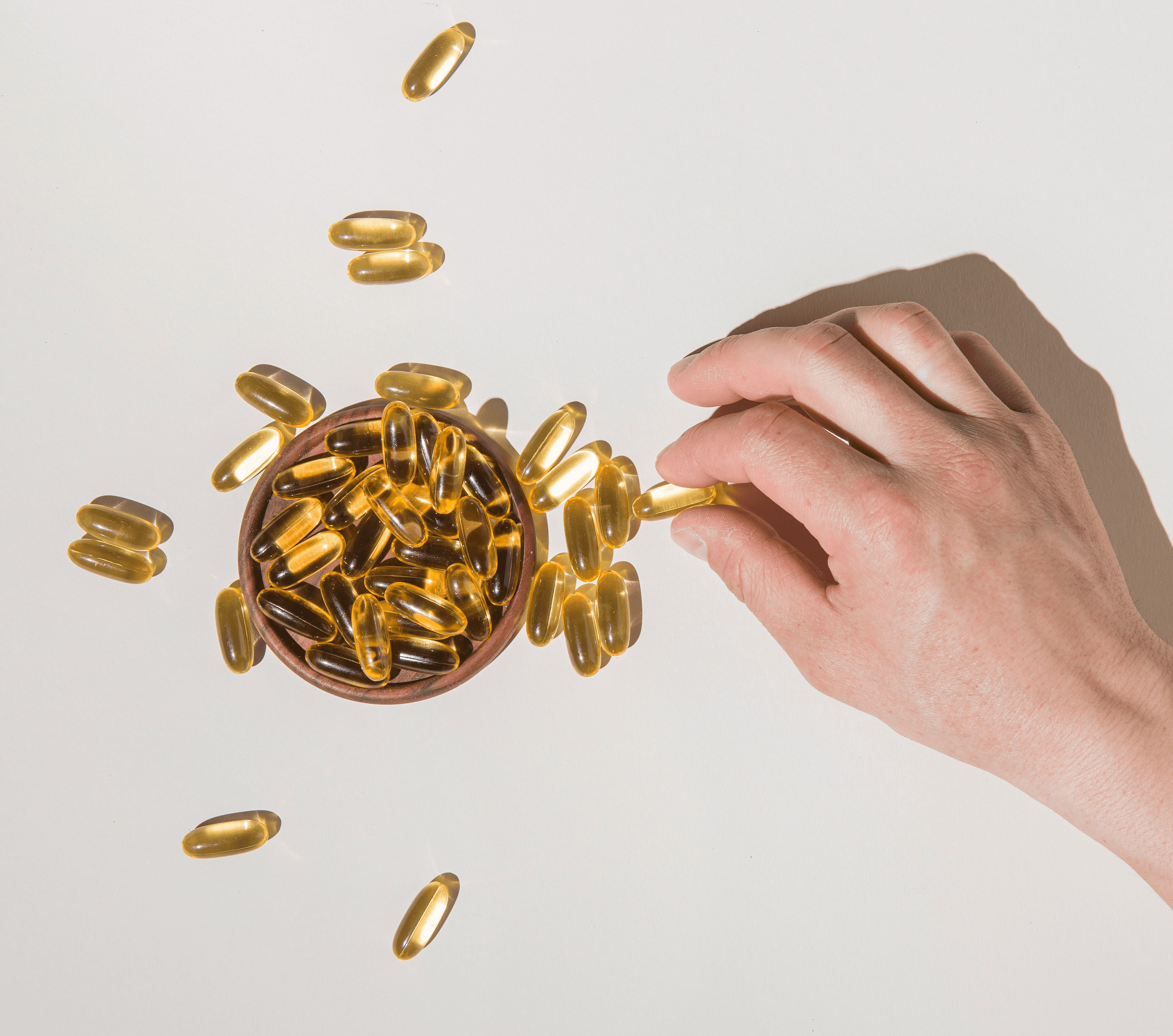Hand holding omega supplements