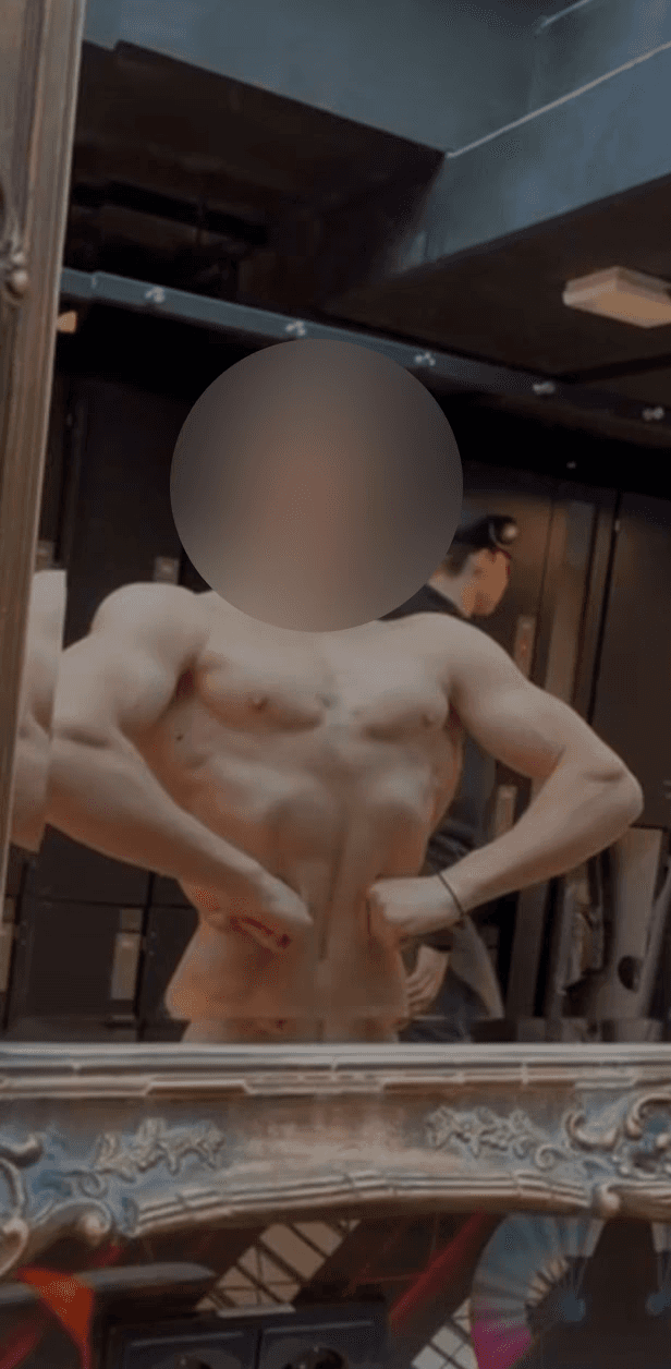 greyscale photo of woman in bralette inside room