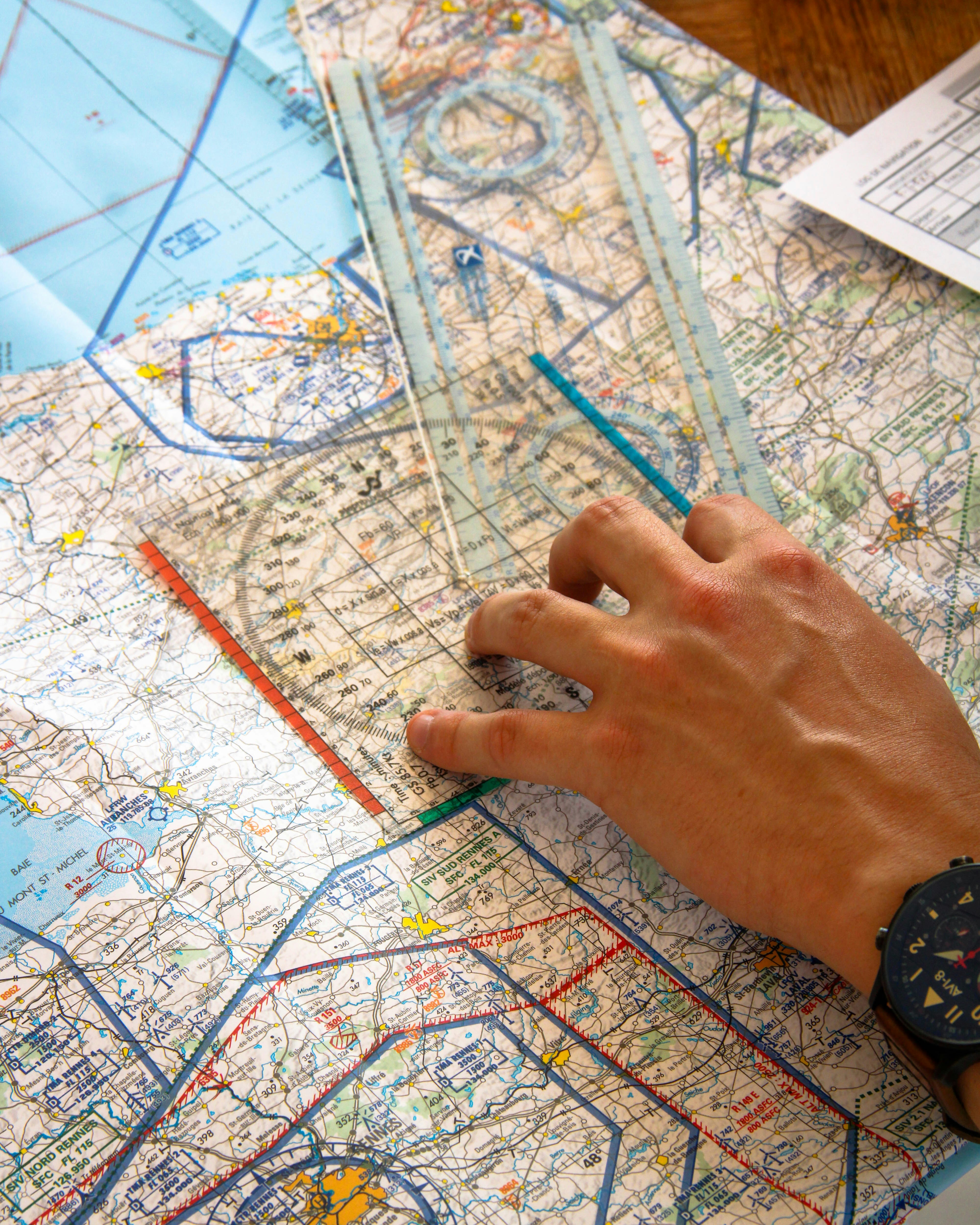Hand using ruler on aviation chart