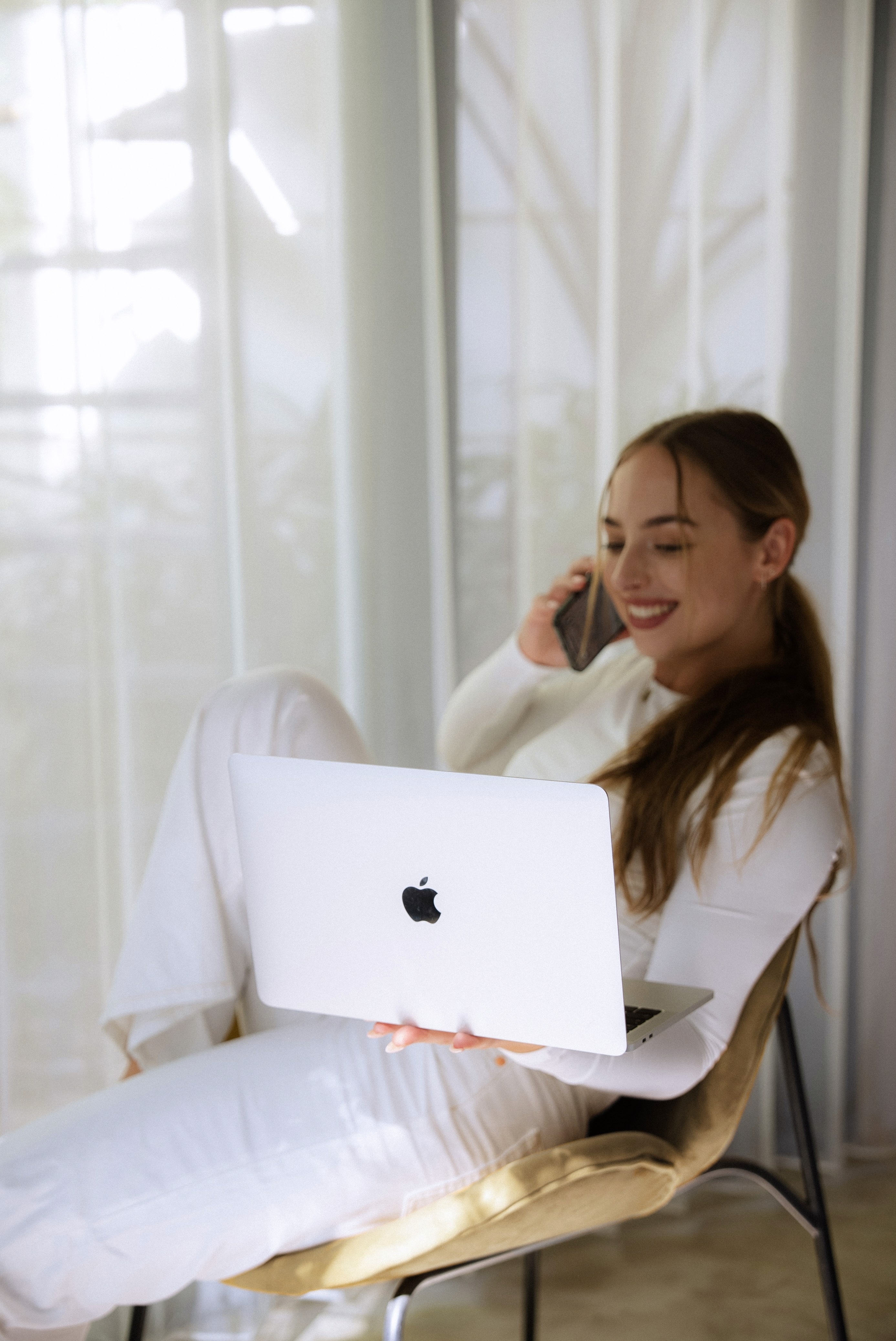 White building with red lighthouse under clear sky.