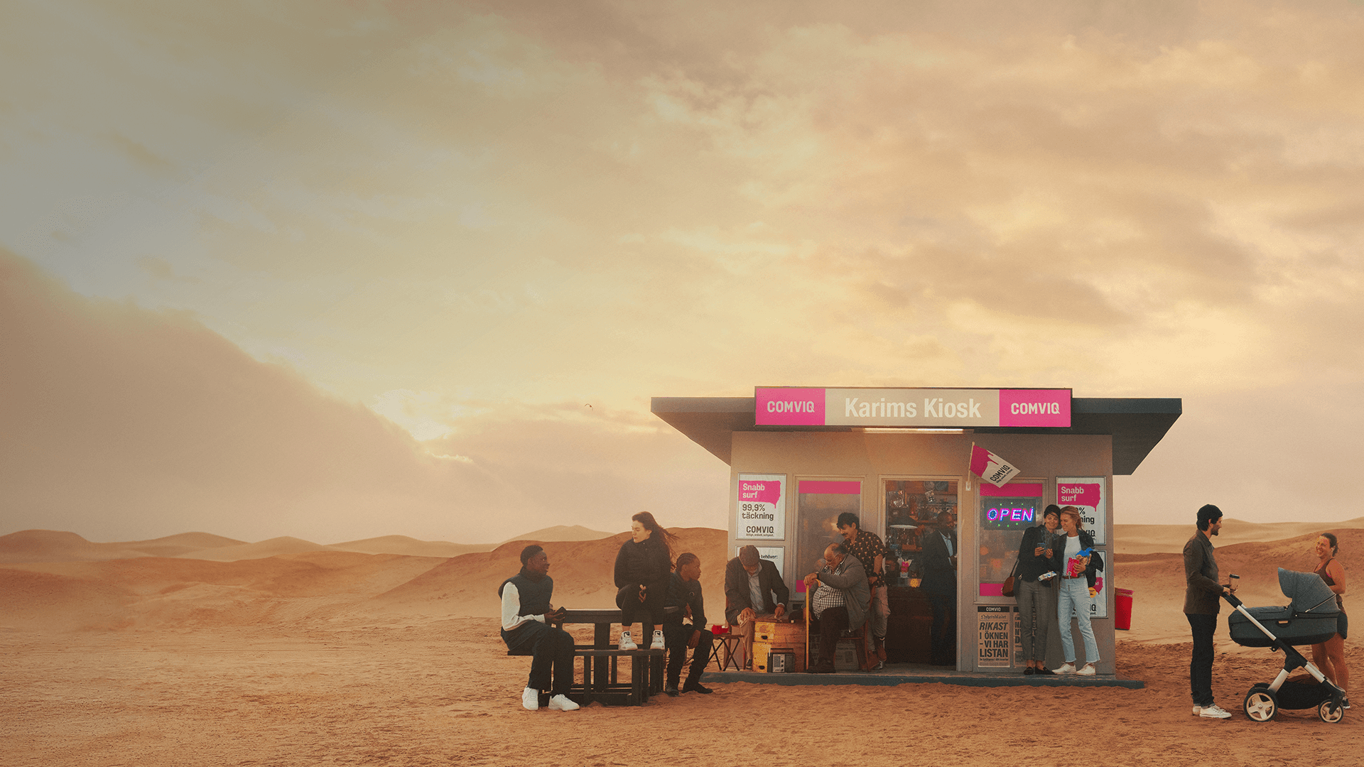 Image if a kiosk in the middle of the desert. people are hanging out infront of the kiosk.