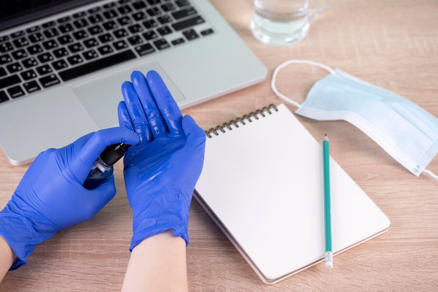 A doctor using hand sanitizer before the checkup.