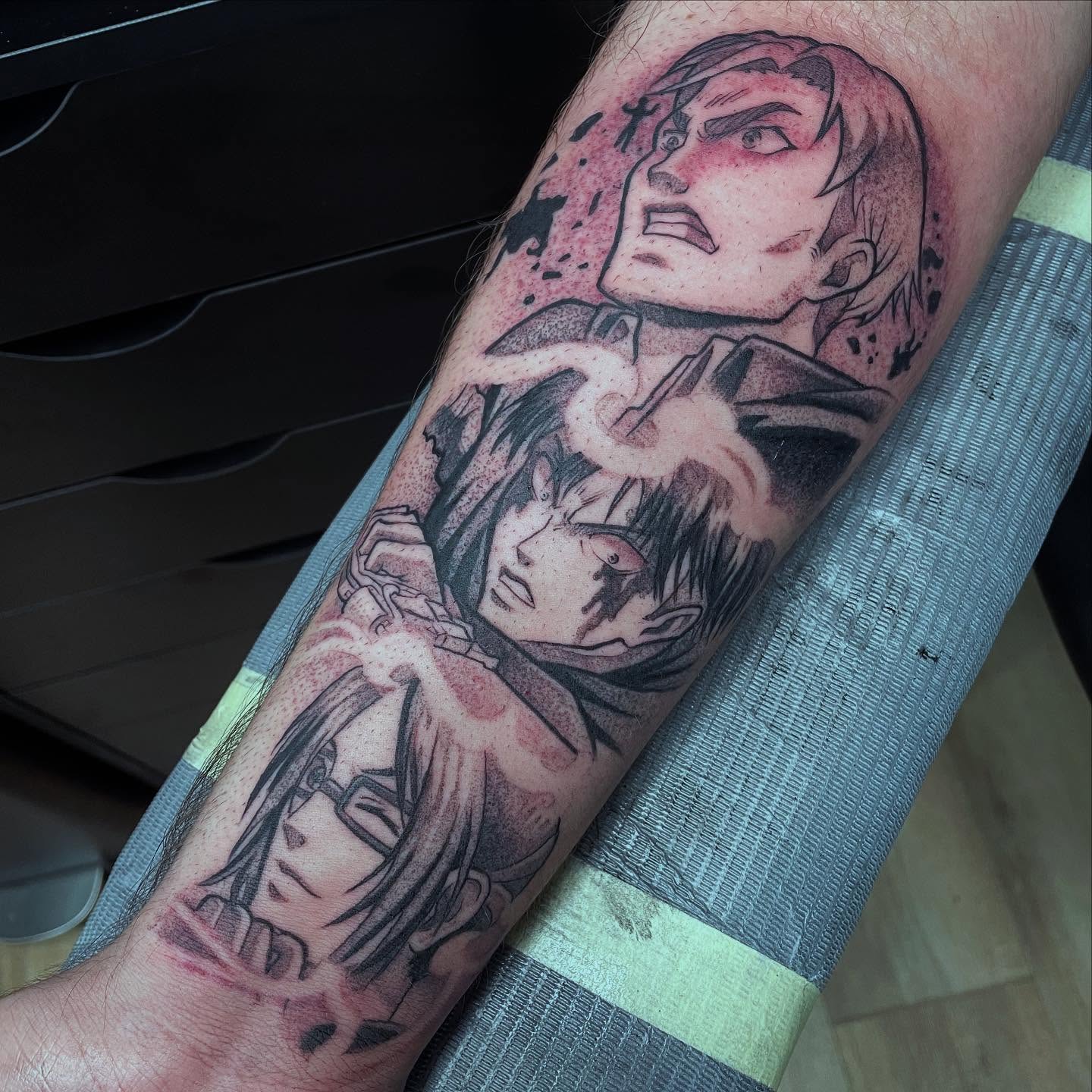 A vibrant tattoo of a chainsaw-like creature on a person's forearm. The tattoo is detailed with shades of orange, black, teal, and red.