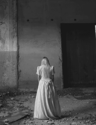 A woman receives a relaxing energy healing in a serene setting with soft lighting.