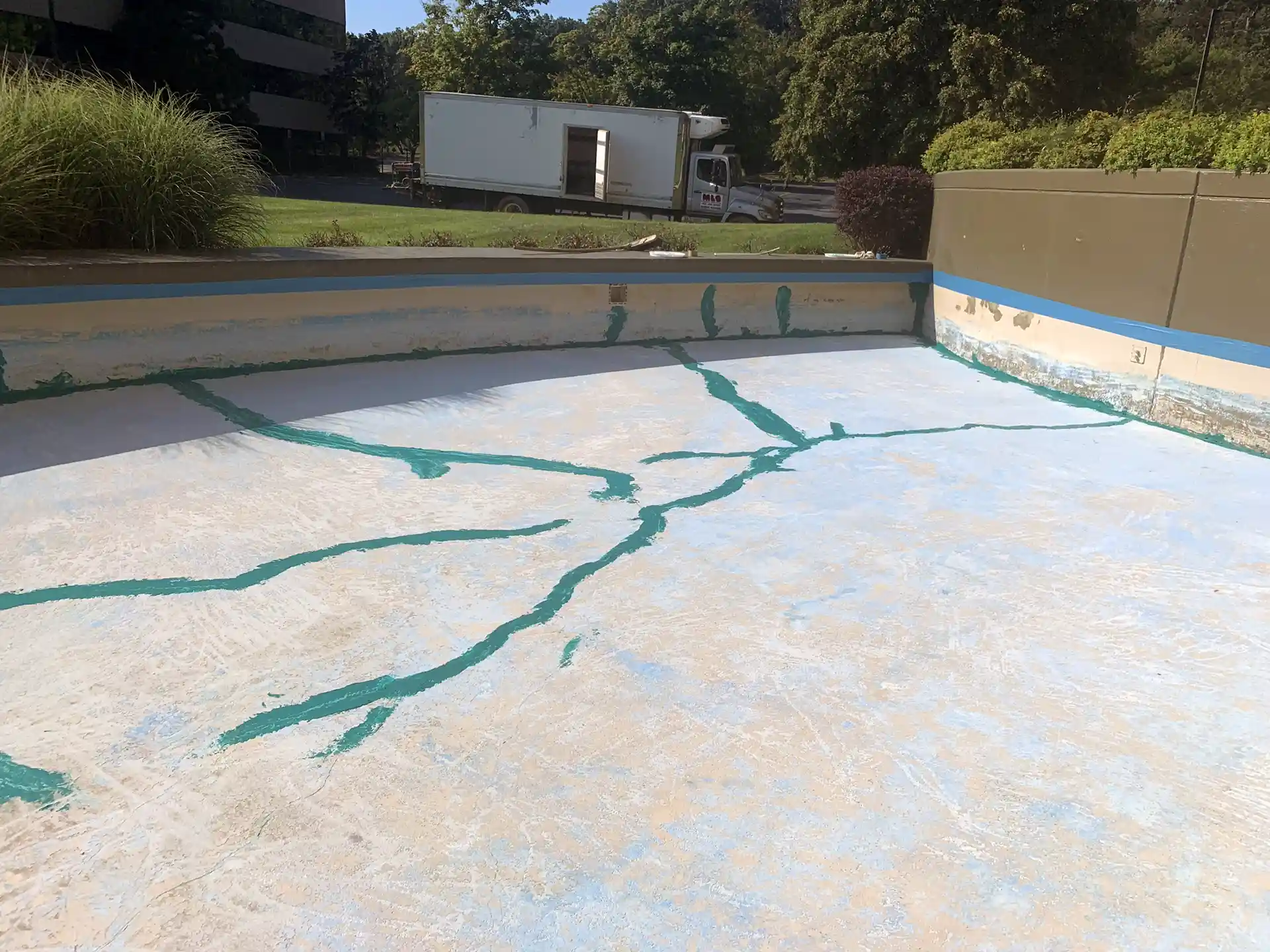 An empty fountain basin with Rub-R-Patch used to seal cracks in the concrete