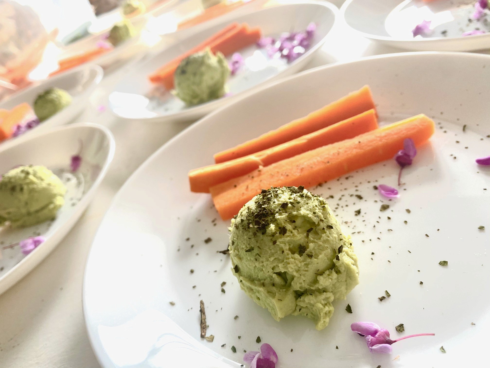 Fresh wild greens and berries in a wooden bowl, representing the hands-on results of Foraging Academy’s certification classes.