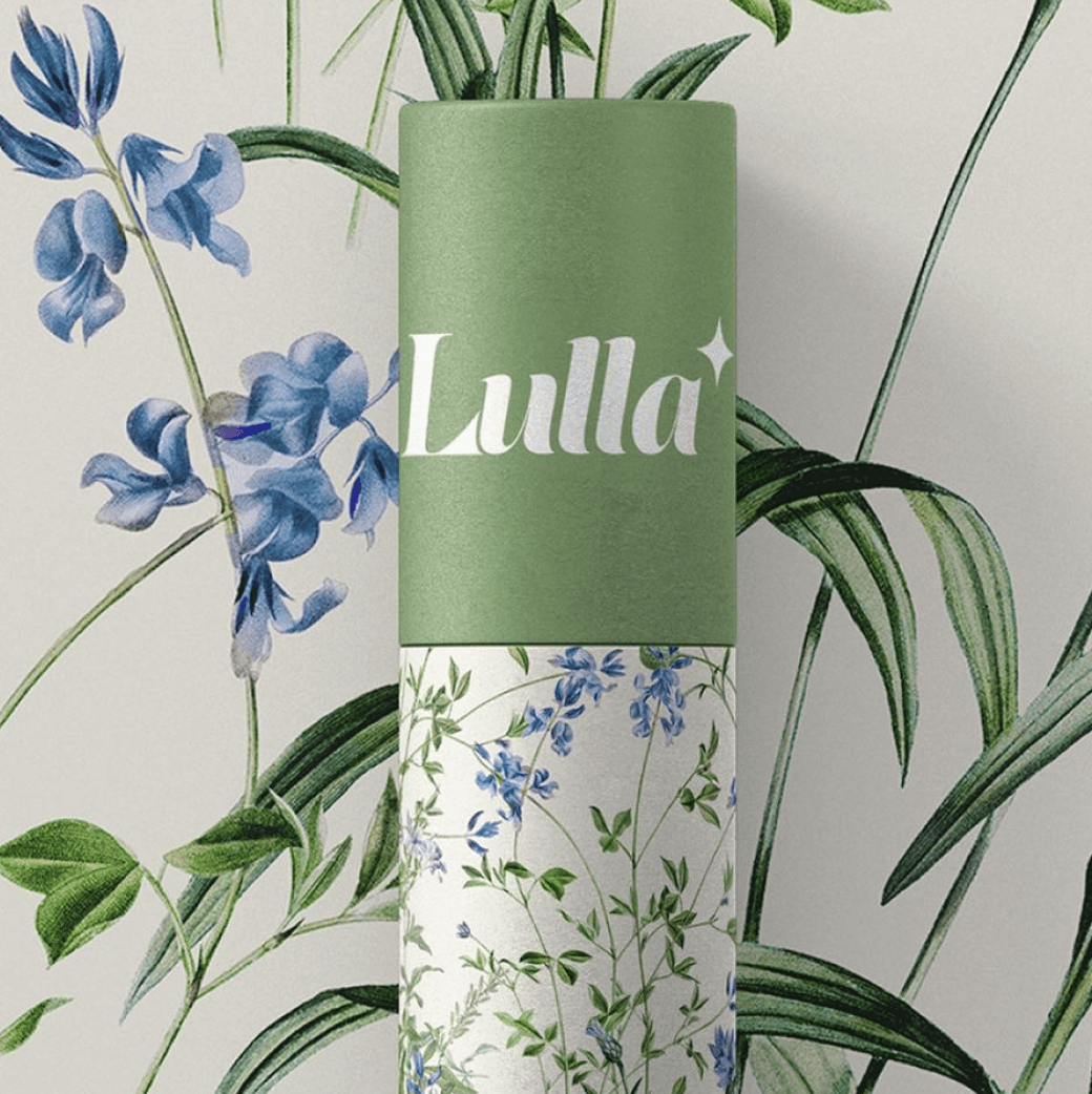 A green tube with the label "Lulla" surrounded by blue flowers and greenery.
