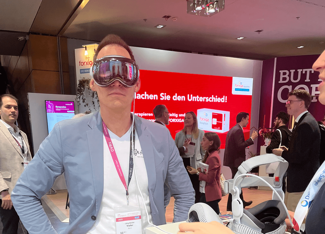 A large group photo of diverse team members gathered in an industrial-style space with arched ceiling.