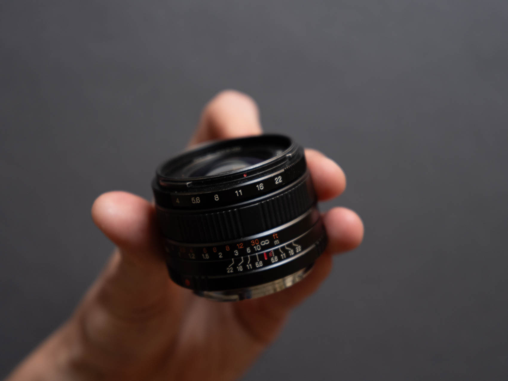 The Hasselblad XPan 45mm lens f/4 held in a hand