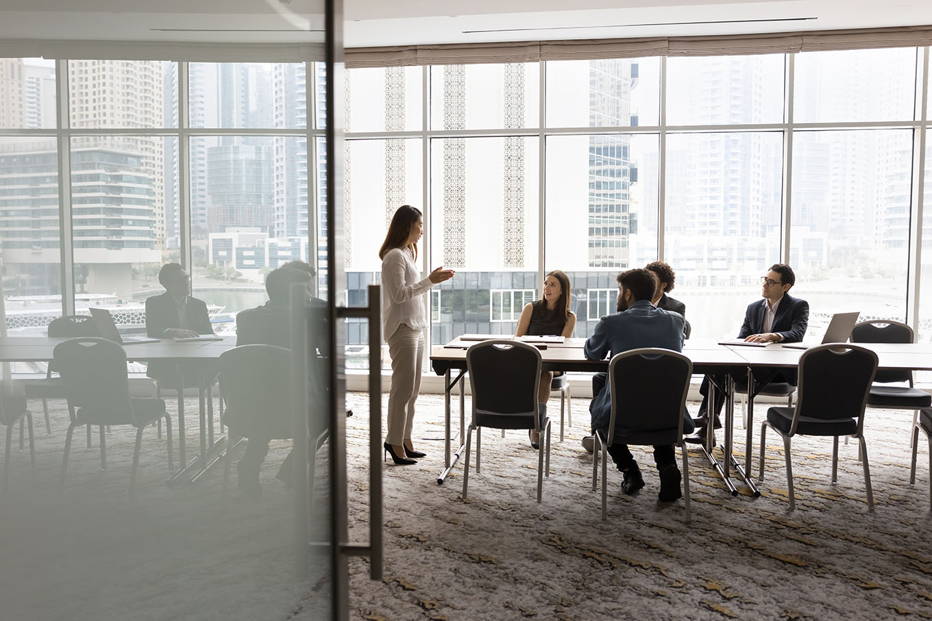 A business team meeting in an office conference room, making efficient use of the available occupancy by myOffice