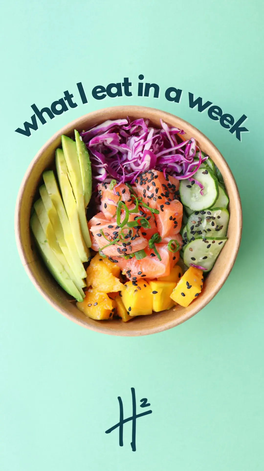 A colorful poke bowl featuring fresh salmon slices, sliced avocado, cubed mango, shredded purple cabbage, cucumber slices, and a sprinkle of black sesame seeds, all arranged neatly in a wooden bowl on a light green background.