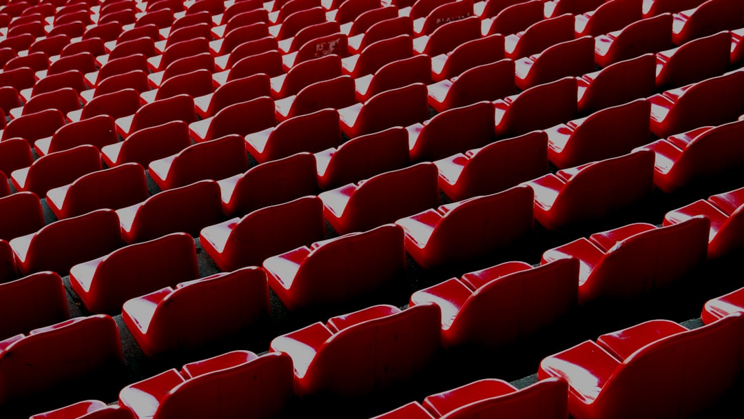 Rows of empty red stadium seats in perspective