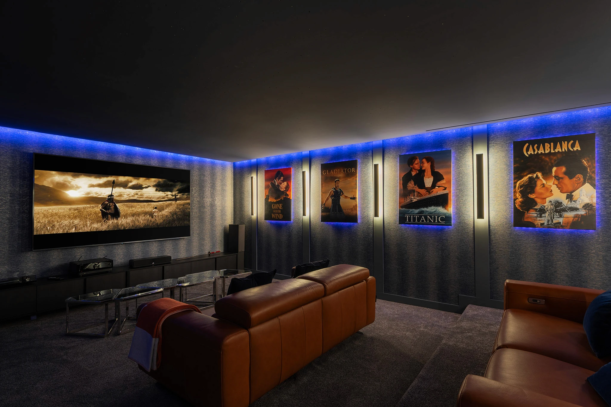 Villa Vista Marbella home cinema with leather recliners, acoustic wall panels, and ambient LED lighting