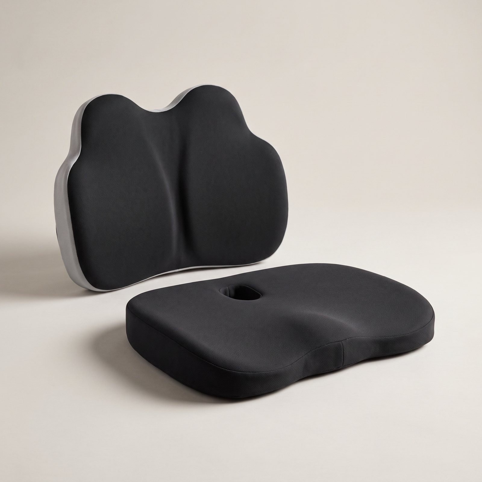Two places, two pieces: a contoured memory-foam seat cushion and a separate lumbar cushion, shown in Black/Grey.
