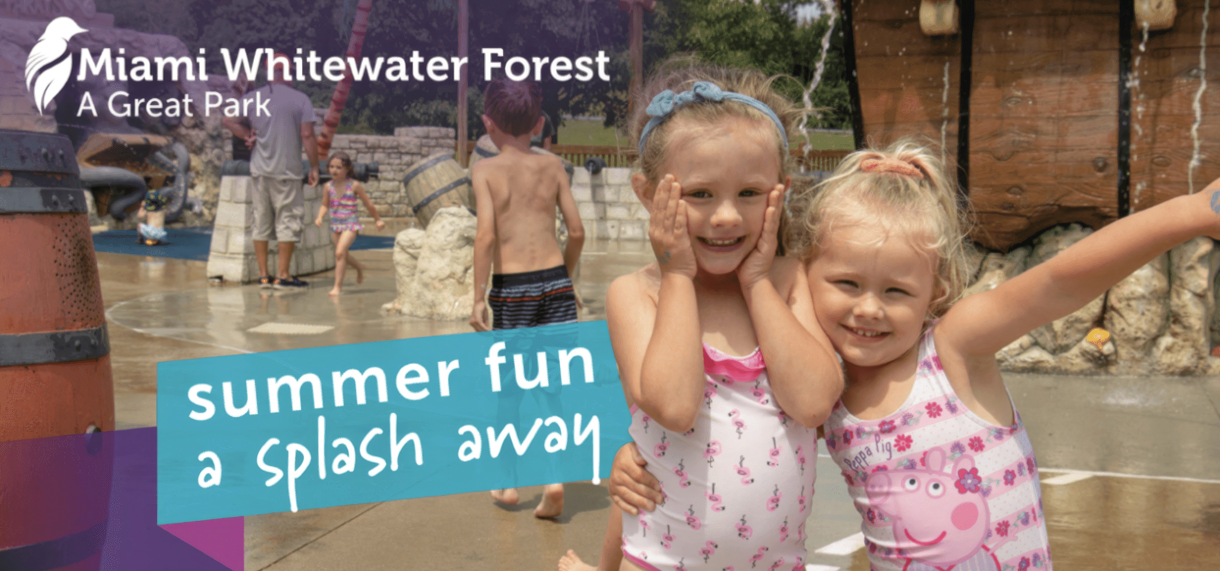 Two young girls smile at the camera at a waterpark