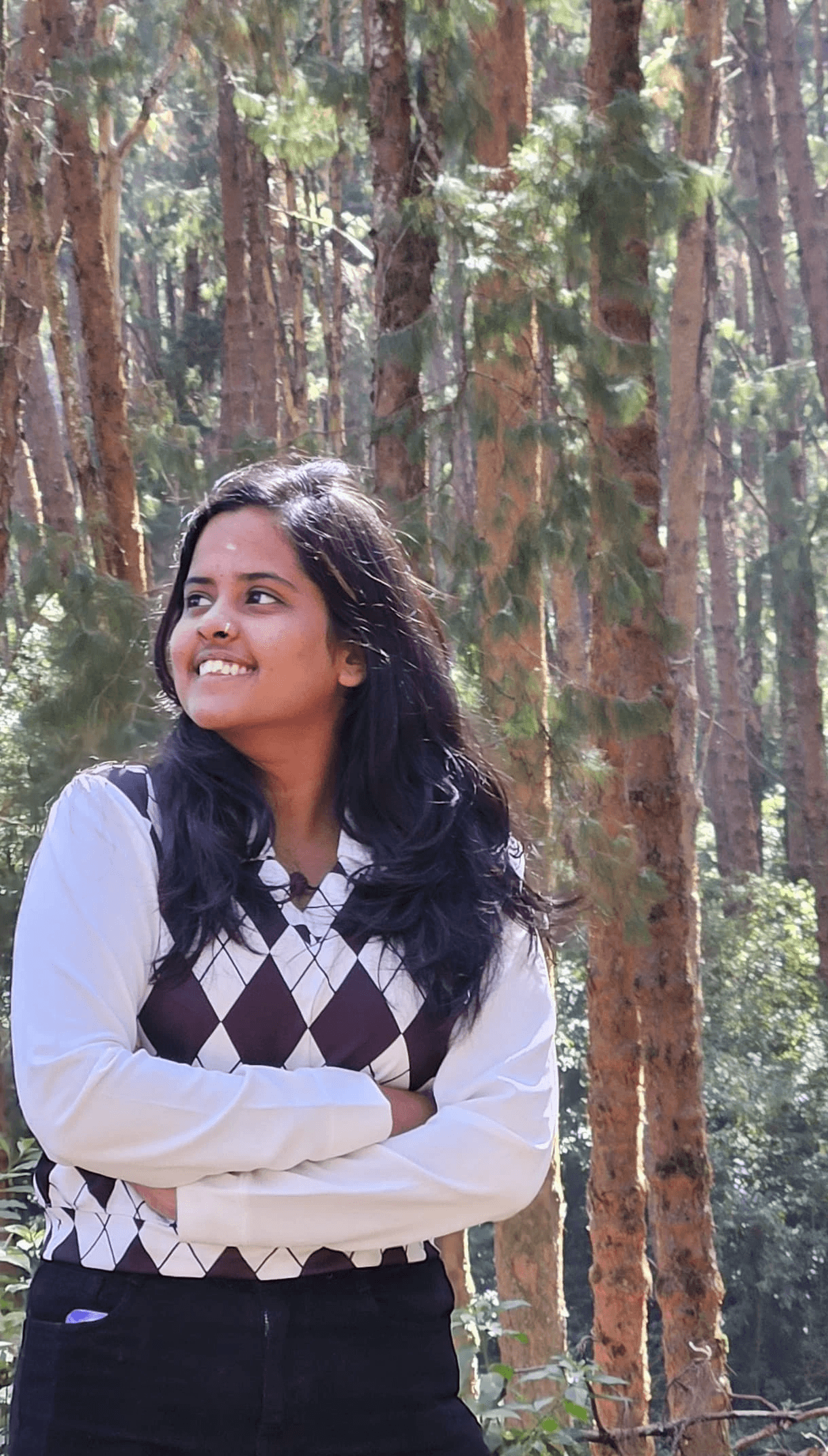 A businesswoman sitting at her desk, smiling and looking at the camera.
