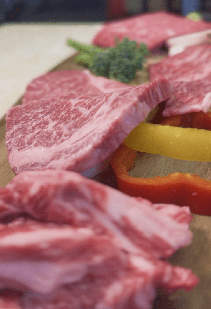 A gourmet plate featuring a golden-brown, breaded chicken cordon bleu or roulade, sliced to reveal a yellow filling, served with a creamy sauce, roasted potato wedges, and a side of fresh salad greens on a wooden table.