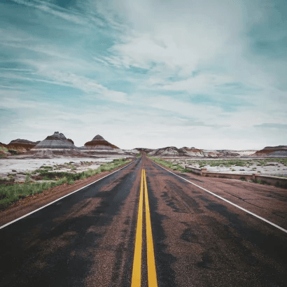 Straight desert highway representing long-haul trucking travel and safety awareness