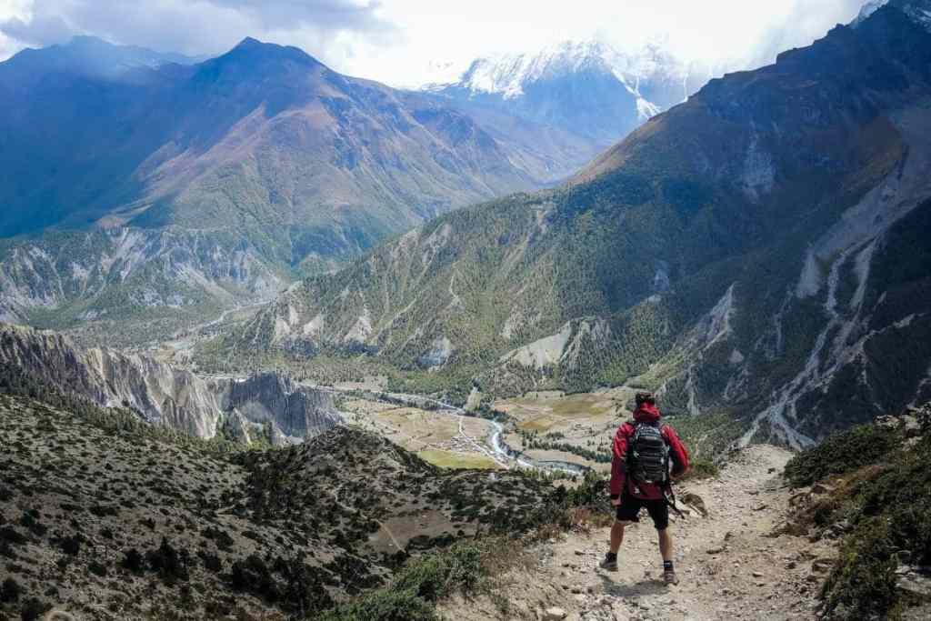 Man looking at mountain range - beginner mountain climbers