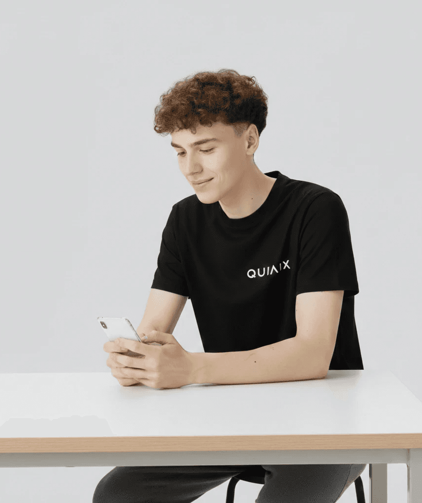 woman sitting around table holding tablet