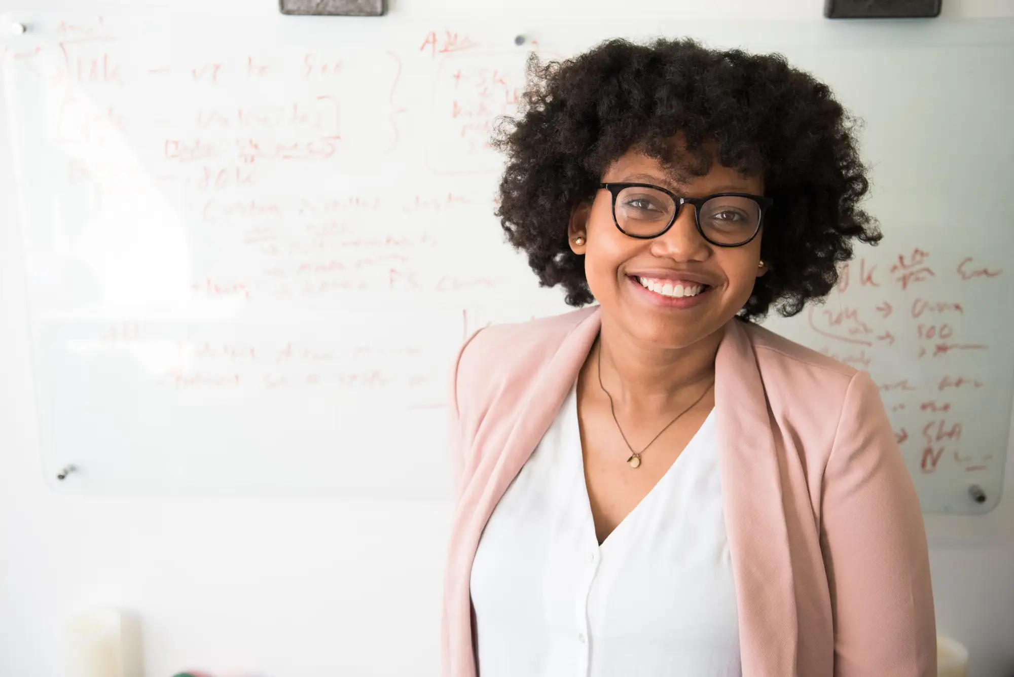 Waman with dark curly hair smiling 