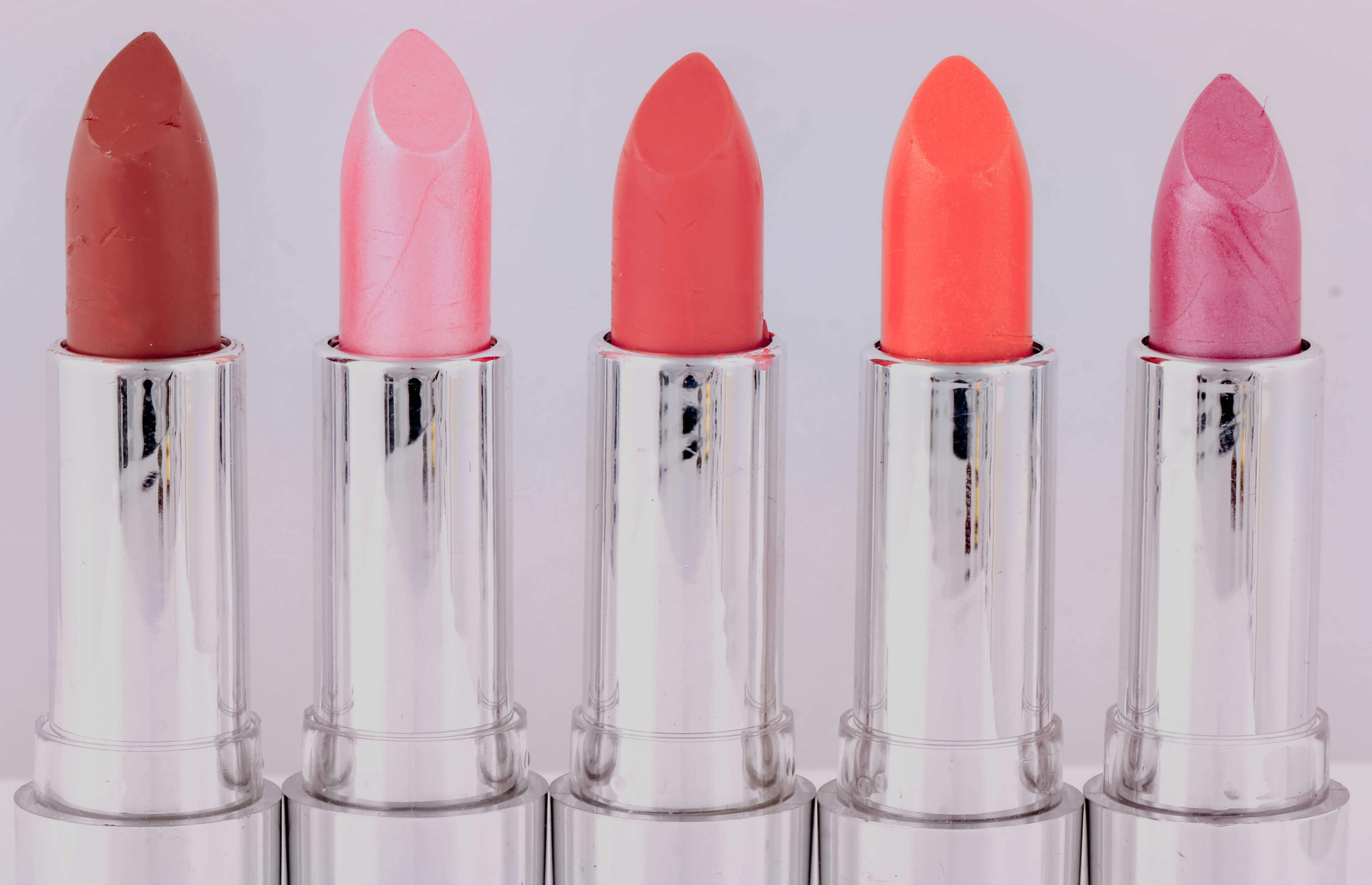 five assorted-color lipsticks
