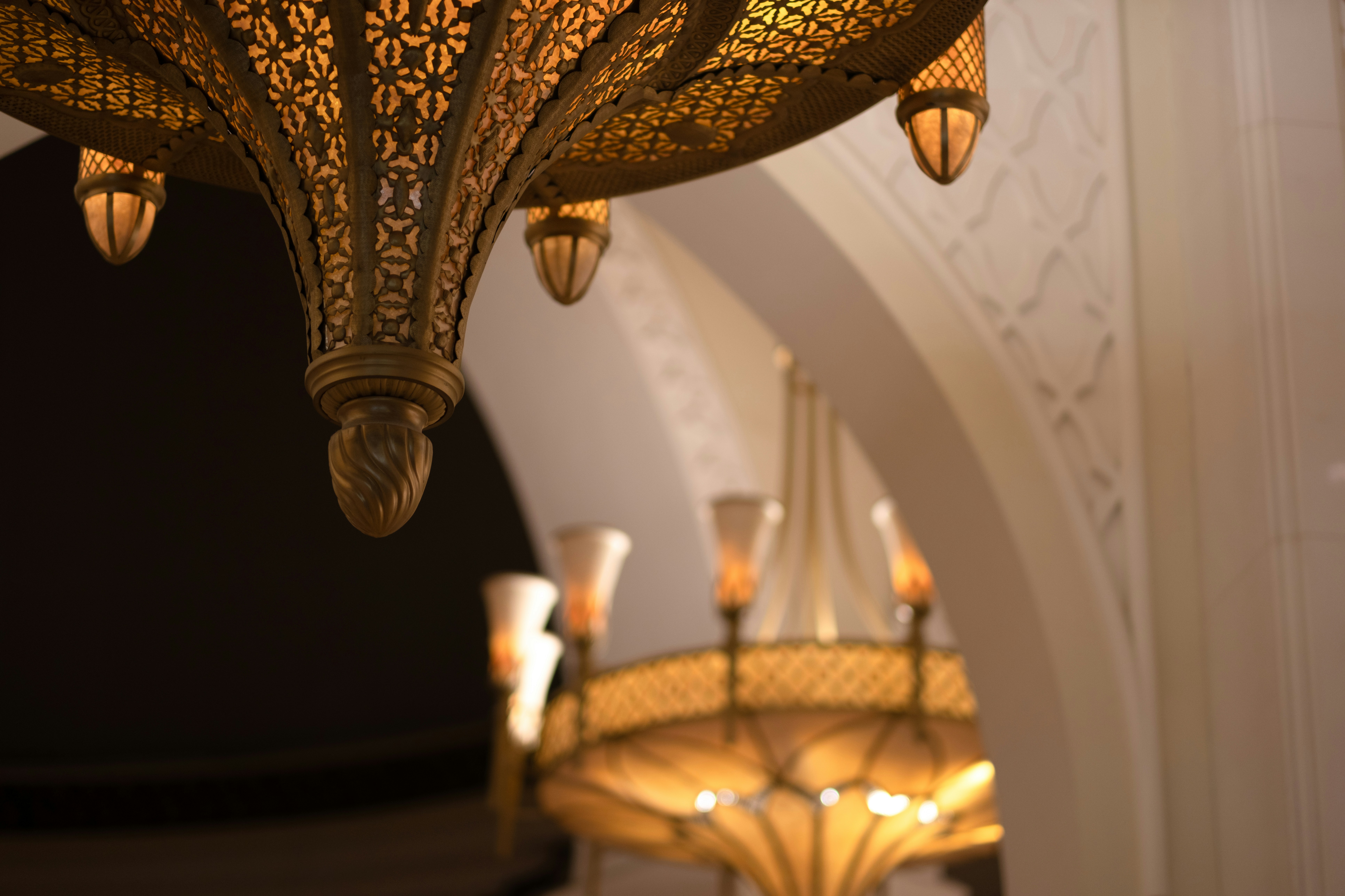 Close-up shot of ornate chandeliers highlighting their intricate details.