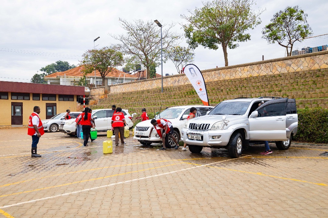 Two cheerful students are balancing books on their heads, smiling and laughing