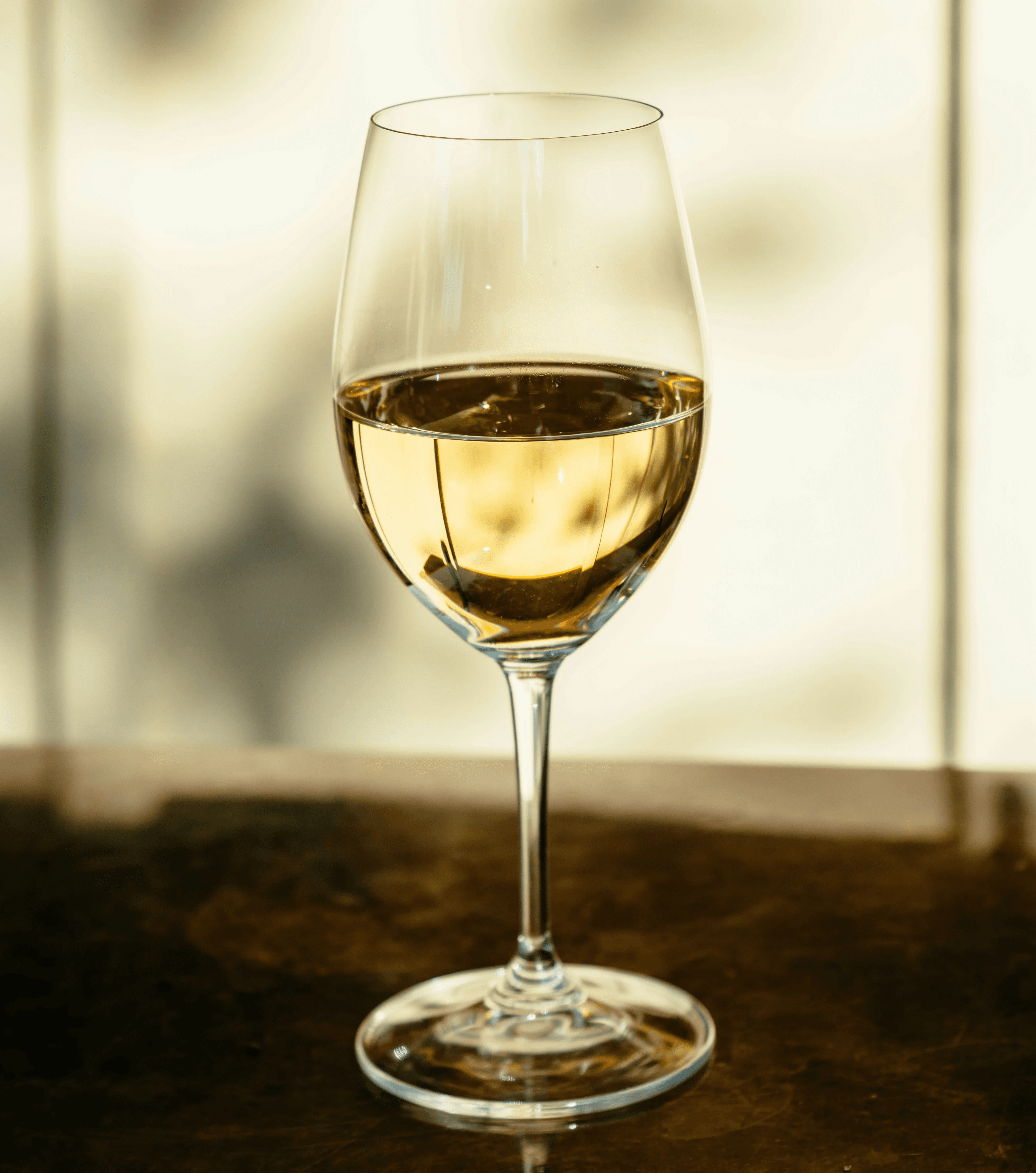 clear wine glass on brown wooden table