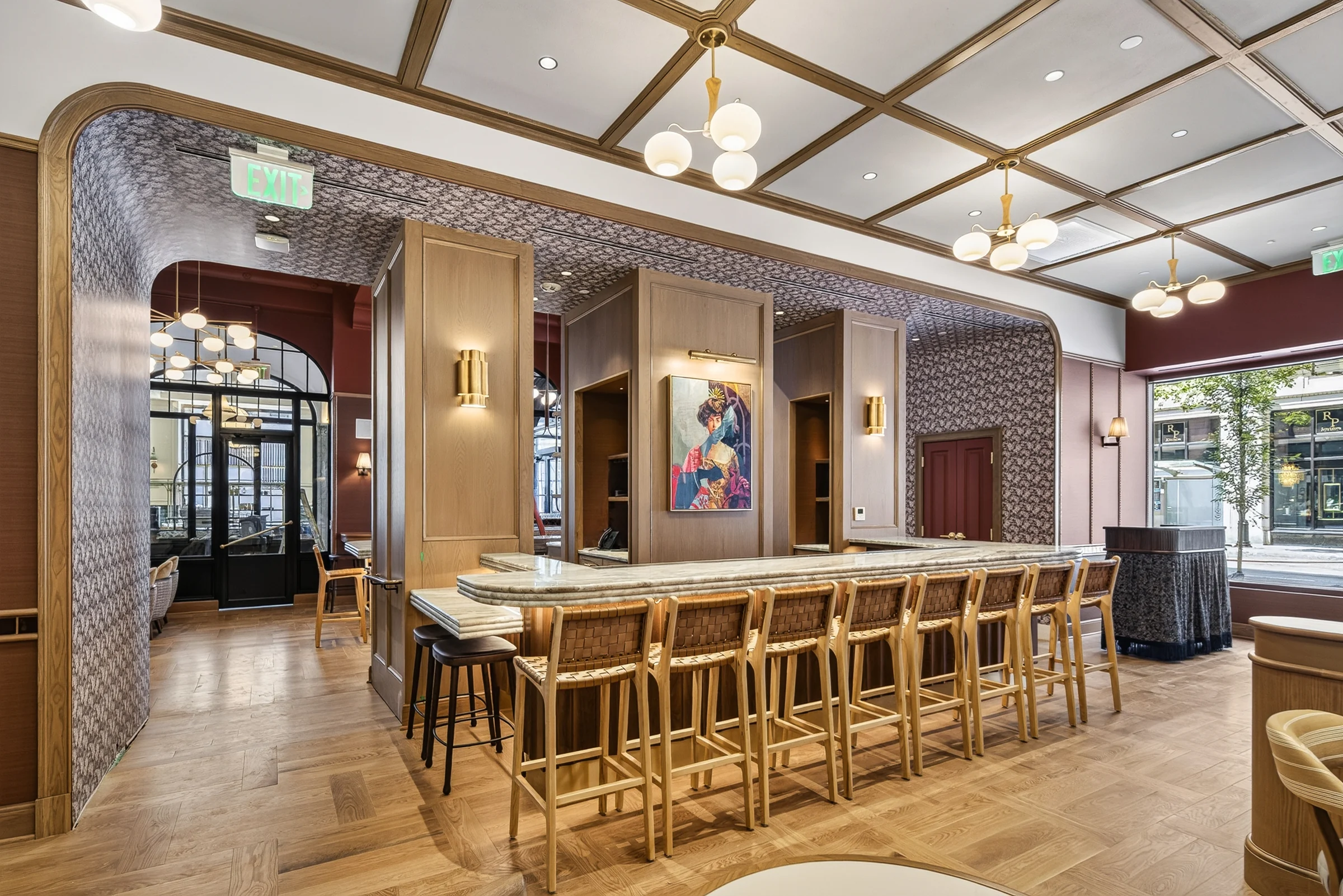 Hospitality bar at 210 E 6th with timber stools, stone counter and globe pendant lights