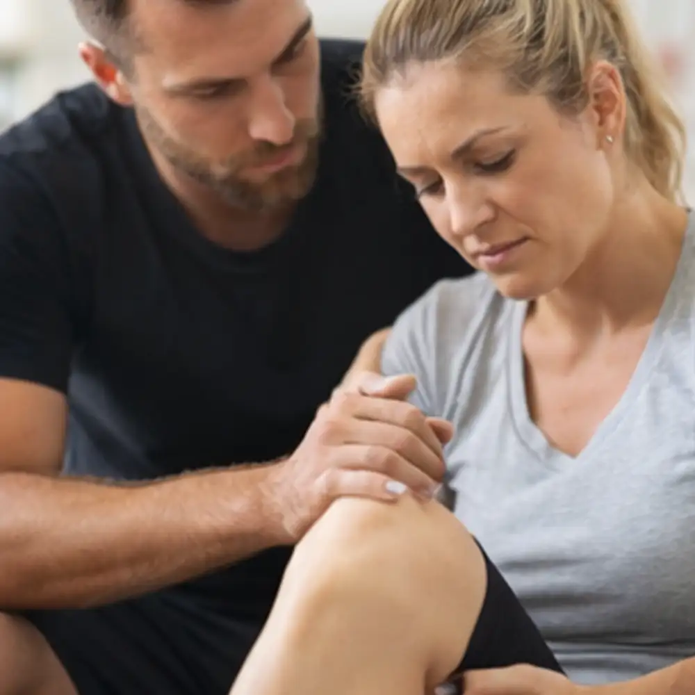 Chiropractor examining a male patient with shoulder pain during a treatment assessment in Draper, Utah