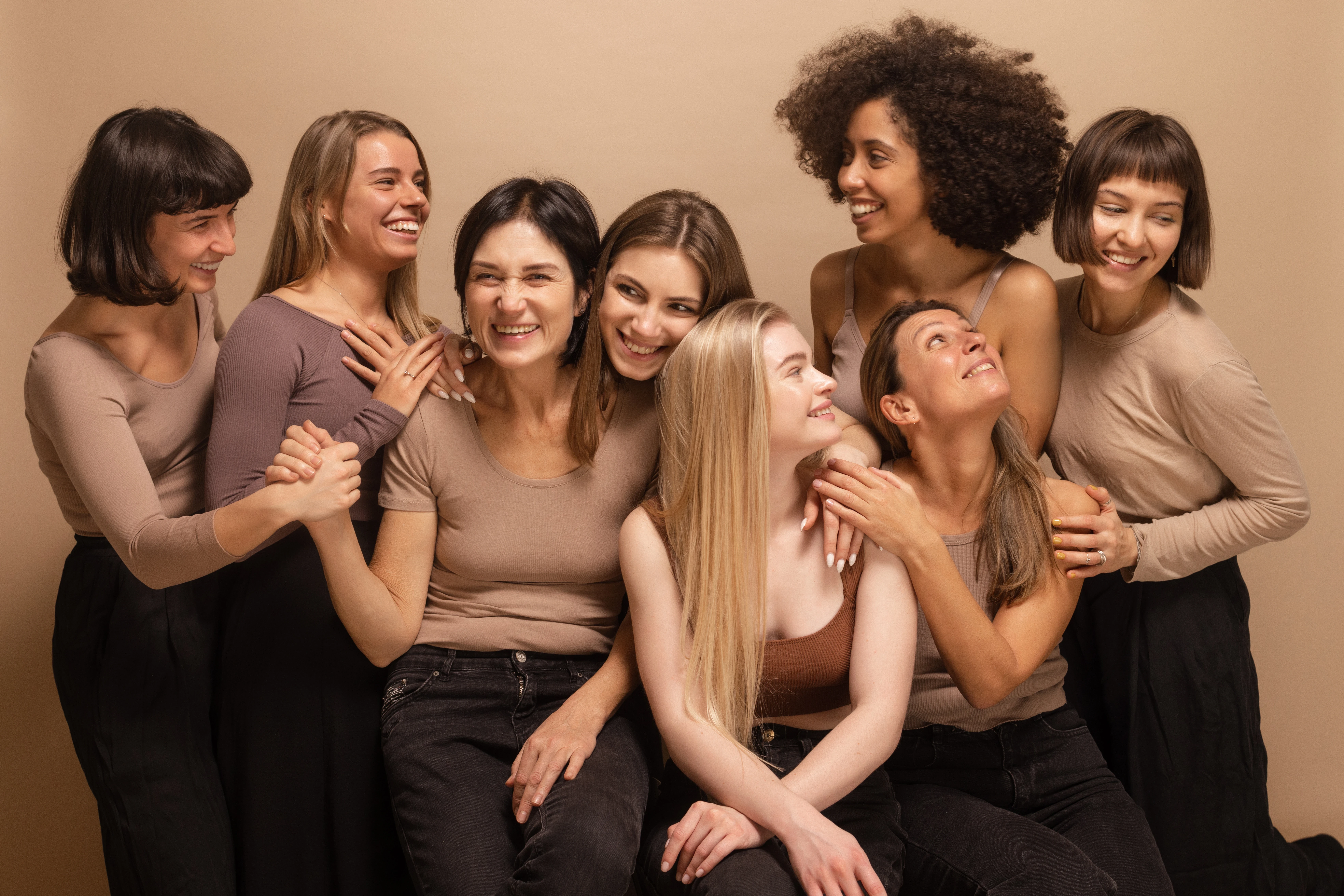 Group of women embracing and smiling together