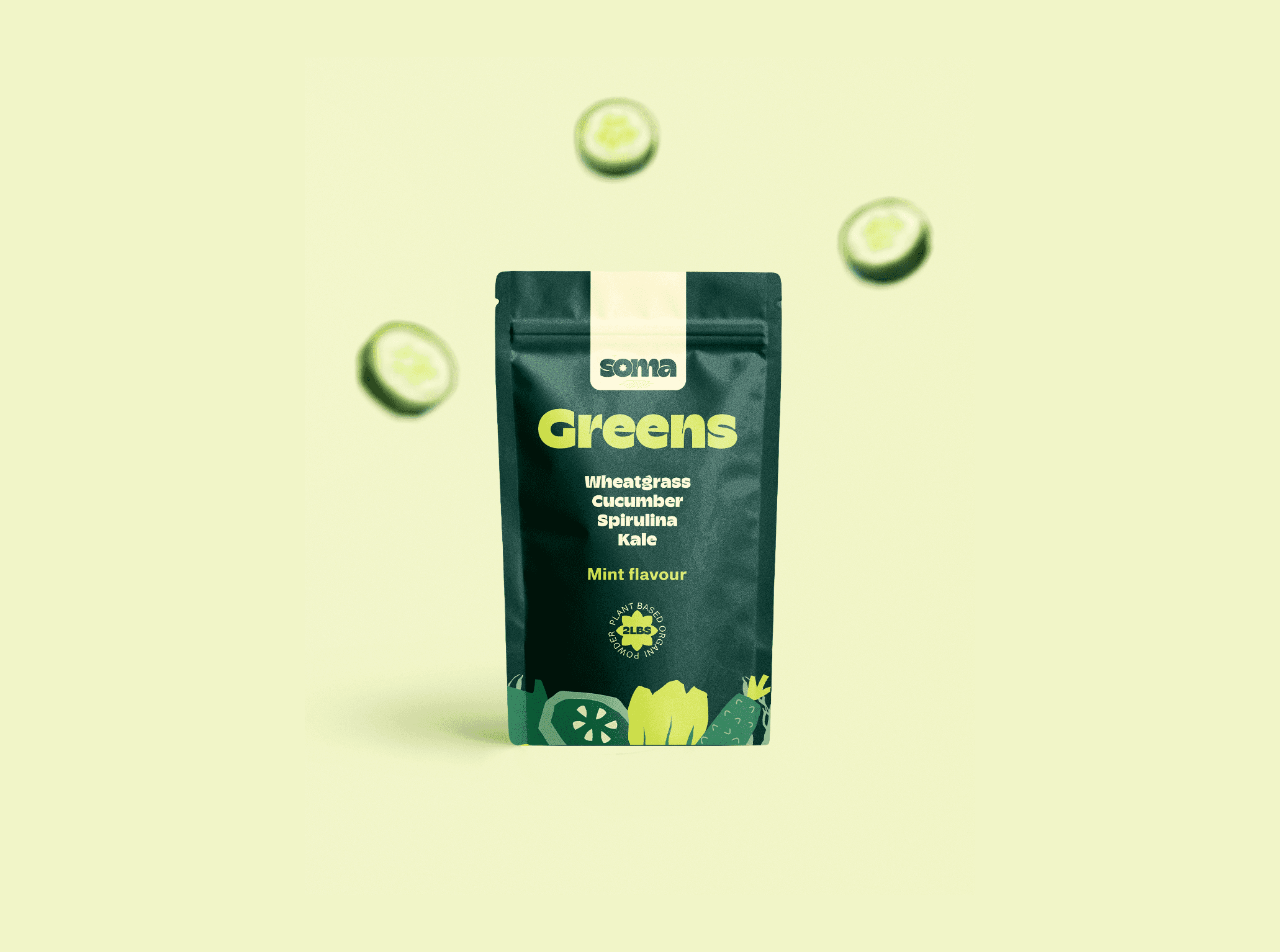 A minimalist studio mockup of the SOMA "Greens" pouch. The deep green packaging is centered on a soft mint background. Out-of-focus cucumber slices float around the pouch, emphasizing the fresh, minty flavor profile and ingredients like wheatgrass, spirulina, and kale.