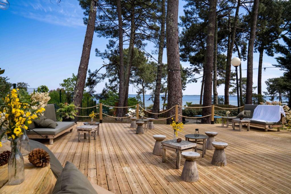 A couple dances closely, showcasing a flowing green dress, against a soft, blurred background of other guests.