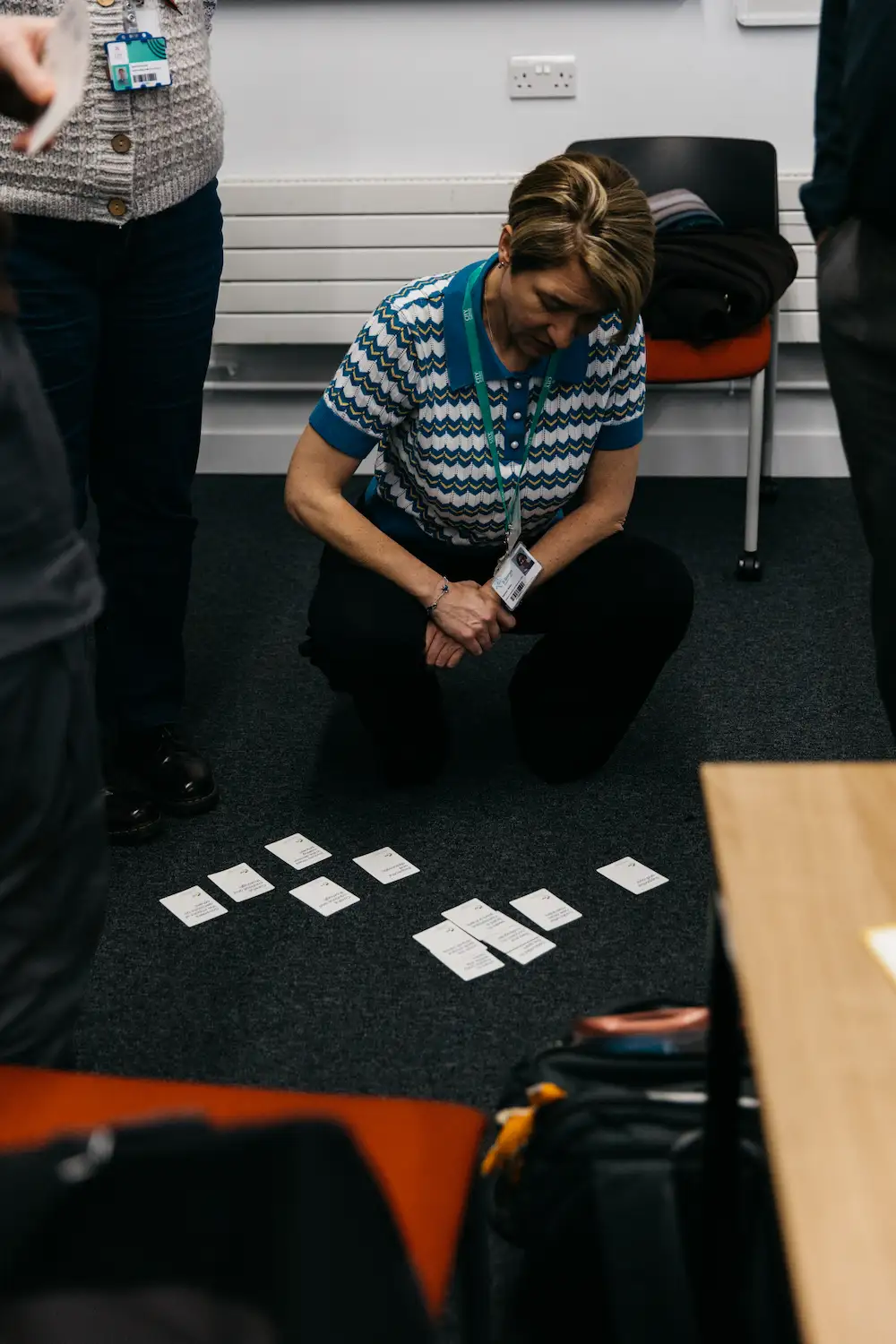 A person sitting on a table with some notes scattered around.