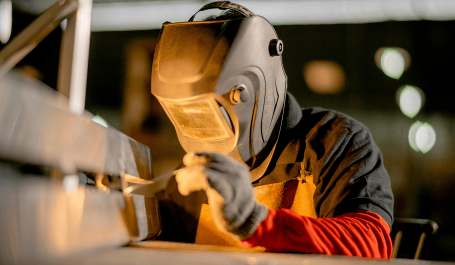 Machine operator working at a CNC lathe on the factory floor