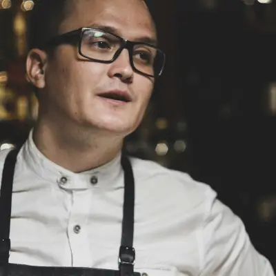 man in white dress shirt and black denim dungarees